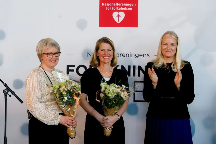 A group of women holding flowers