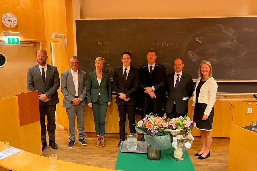 A group of people standing in front of a chalkboard