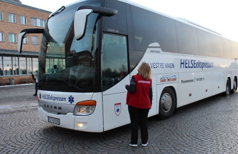 A person standing next to a bus